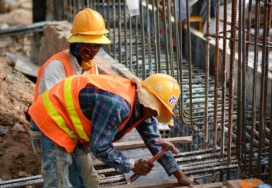Construction crew tying reinforcement steel on a site