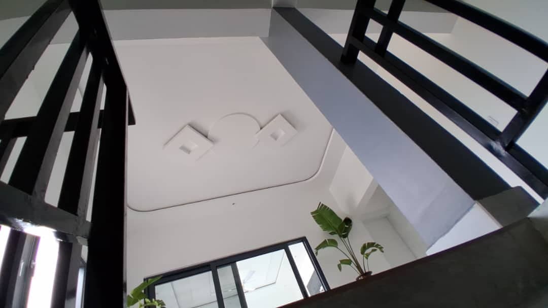 Stairwell landing in Ghana with a circular POP medallion ceiling detail